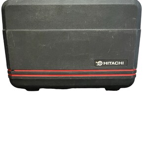 May include: Black hard-shell carrying case with a red stripe and the Hitachi logo.