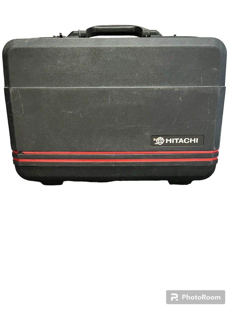 May include: Black hard-shell carrying case with a red stripe and the Hitachi logo.