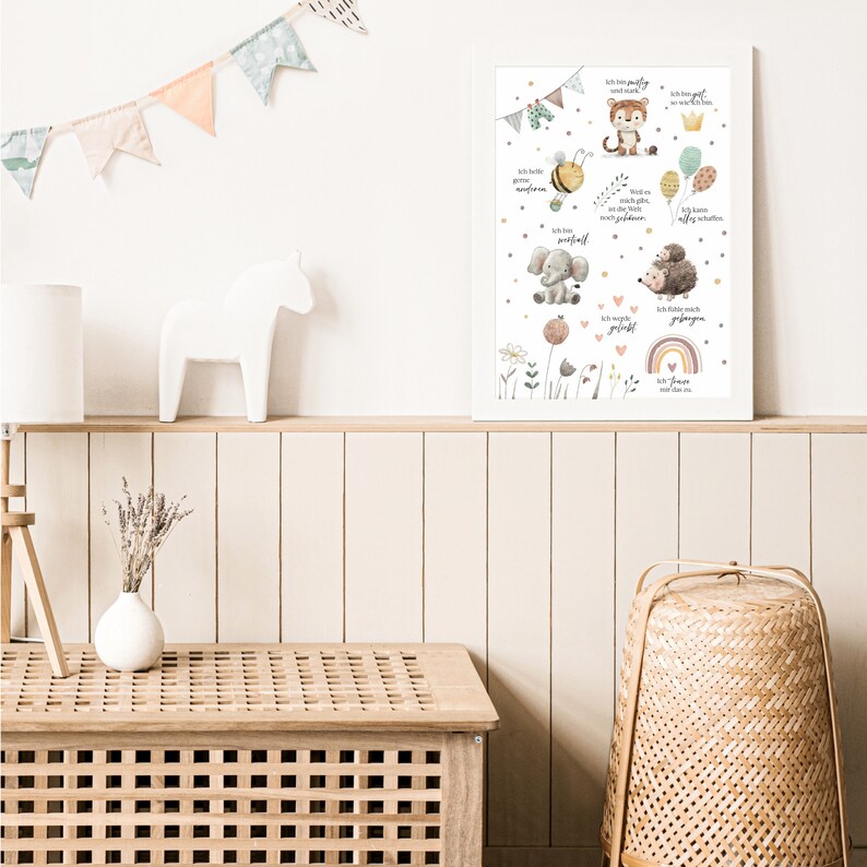 May include: A white framed print with a colorful illustration of animals and text in German. The print features a bee, elephant, tiger, hedgehog, and rainbow. The text says "Ich bin mutig", "Ich bin freundlich", "Ich bin stark", "Ich bin klug", "Ich bin neugierig", "Ich bin gl&uuml;cklich", "Ich mag es zu lernen", "Ich mag es zu spielen", "Ich liebe dich", "Ich bin dankbar", "Ich bin einzigartig", "Ich bin perfekt so wie ich bin".