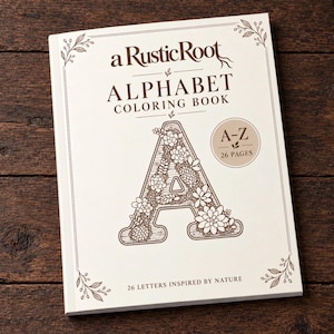 Può includere: Un libro da colorare con copertina flessibile intitolato a Rustic Root Alphabet Coloring Book con una grande lettera A riempita di illustrazioni di piante grasse sulla copertina. Il testo A-Z 26 Pages e 26 Letters Inspired by Nature è stampato in marrone.