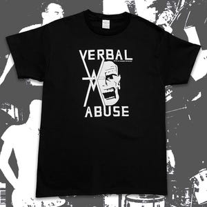 May include: Black t-shirt with the words "VERBAL ABUSE" in white, along with a stylized graphic of a screaming face. The text "JUST AN AMERICAN BAND" is above the face. The shirt has a crew neck.