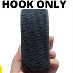May include: A black hook and loop fastener, also known as Velcro, is held in a hand. The text "BLACK HOOK ONLY" and "ROUGH VELCRO" are displayed in bold, black letters.