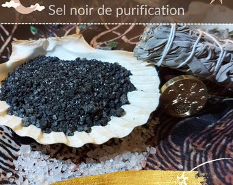 May include: Black salt crystals in a white seashell, with a bundle of white sage and a gold wax seal. The text "Protégez-vous! Sel noir de purification" is written in French above the image. The text "Le Bois Sacré de Nemetona" is written in French below the image.