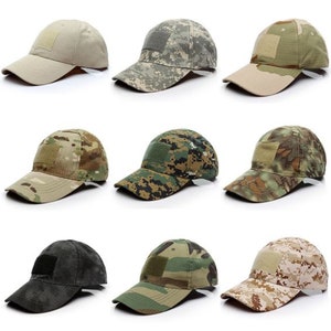 May include: Nine different camouflage baseball caps with a velcro patch on the front. The caps are in various shades of green, brown, and tan.