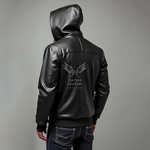 May include: Black leather jacket with a hood. The jacket has a zip fastening and a logo on the back that says "Leather Craftery Premium Leather".