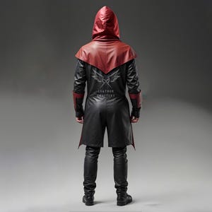 May include: A black leather hooded coat with a red hood and red accents. The coat has a long, flowing design and is worn over black pants. The back of the coat features a logo that says "Leather Craftery".