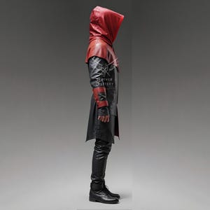 May include: A black and red leather hooded coat with a long, flowing design. The coat has a zipper closure and a high collar. The hood is lined with red leather and has a drawstring closure.