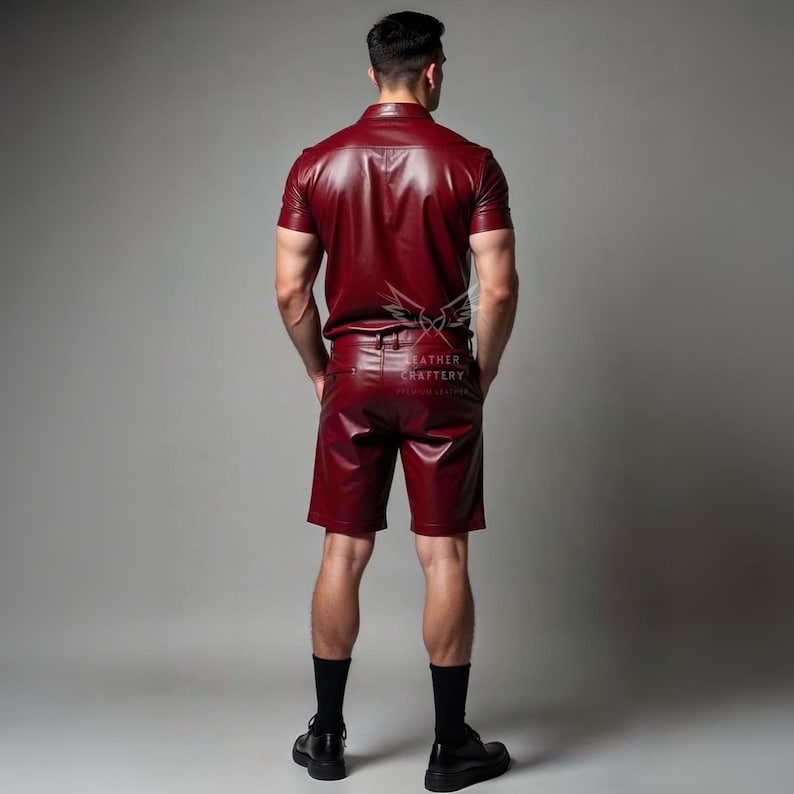 May include: A burgundy leather shirt and shorts set. The short-sleeved shirt has a button-down front and a collar. The shorts have a tailored fit. The set is made of a shiny leather material.