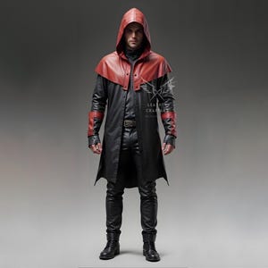 May include: A black leather trench coat with a red leather hood and accents. The coat has a long length and a fitted silhouette. The model is wearing black pants and boots.