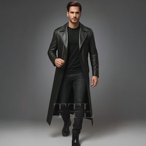 May include: A long, black leather trench coat with a classic design. The coat features a notched collar, a button-down front, and a long, flowing silhouette. The model is wearing a black shirt and black jeans.