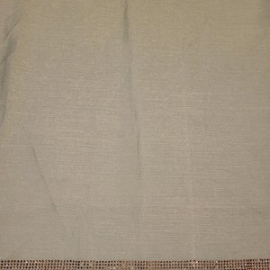 May include: A light green fabric with a silver shimmer and a row of rhinestones along the bottom edge.