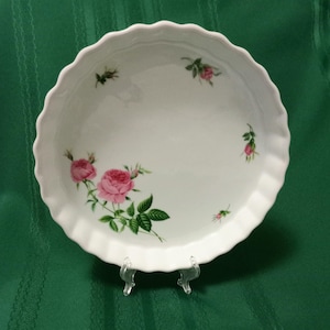 May include: White ceramic baking dish with a scalloped edge and a floral design featuring pink roses and green leaves.