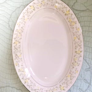 1970's Beautiful Spring Garden By Crown Ming. White, Double Trimmed With Silver With Translucent Blue And Yellow Flowers. Platter, 9 Plates