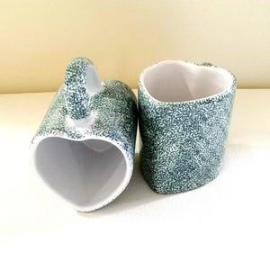 Set Of 2 Heart Shaped, 8 Oz. White And Green Spongeware Mugs By ABC. White Stoneware With Green Sponged Pattern