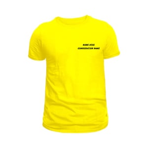 Puede incluir: Una camiseta amarilla brillante de manga corta. La camiseta tiene el texto "NAME HERE" y "CONGREGATION NAME" en negro cerca del pecho. La prenda está hecha de una tela suave y se muestra sobre un fondo blanco.