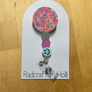 Glow in the dark smiley face badge reel