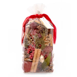 May include: A clear cellophane bag filled with potpourri, tied with a red ribbon. The potpourri includes cinnamon sticks, pine cones, star anise, and red berries. A tag is attached to the ribbon.