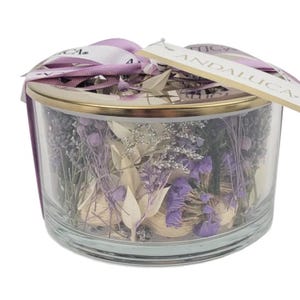May include: A clear glass jar with a gold lid filled with dried lavender and other flowers. The jar has a purple ribbon tied around it with a tag that says "ANDALUCIA".