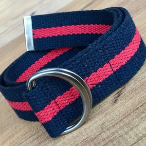 May include: A black and red striped fabric belt with a silver metal buckle and a silver metal D-ring.