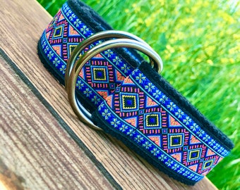 May include: A blue, pink, and yellow patterned dog collar with a silver double D-ring buckle.