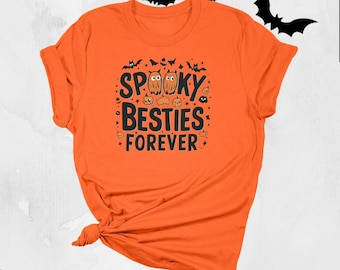May include: Orange t-shirt with the text "Spooky Besties Forever" in black, along with illustrations of owls, pumpkins, and bats. The shirt is tied at the bottom. Halloween-themed apparel.