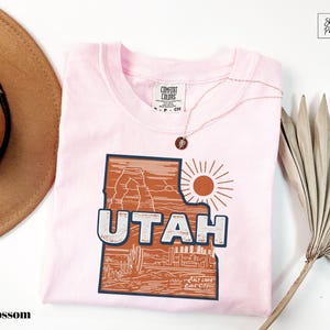 a pink shirt with the word utah printed on it