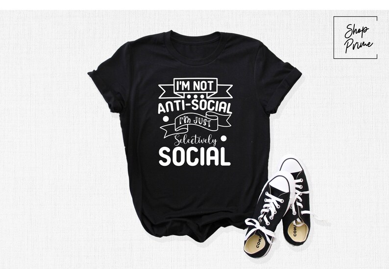 May include: Black t-shirt with white text that reads "I'm not anti-social I'm just selectively social".