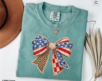 T-shirts Comfort Colors® pour le 4 juillet, T-shirts Coquette avec drapeau américain, T-shirts à nœud papillon USA, T-shirts du 4 juillet, T-shirts à nœud papillon patriotiques, T-shirts Coquette à nœud papillon USA