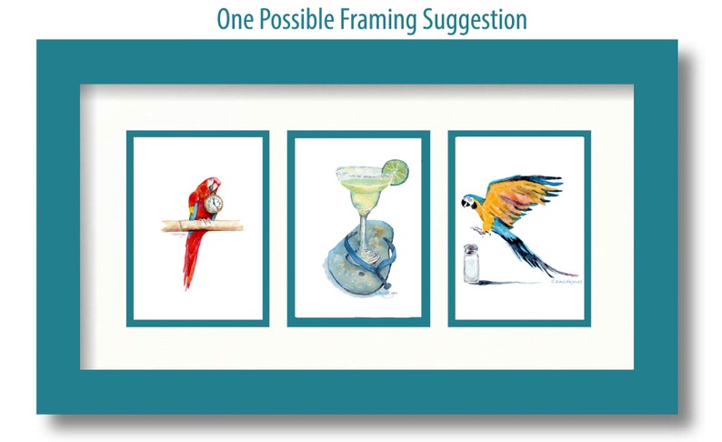 May include: Three watercolor paintings in a white mat and teal frame. The paintings depict a red and blue macaw holding a clock, a margarita in a glass on a flip-flop, and a blue and yellow macaw flying towards a salt shaker.