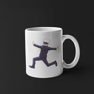 May include: White ceramic mug with a cartoon image of a character with white hair and a black eye mask running with a happy expression. The character is wearing a black jacket and black pants. The background is white with yellow stars.