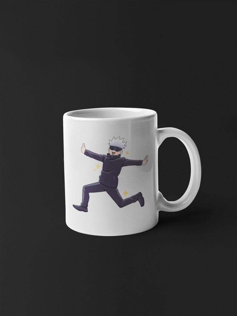 May include: White ceramic mug with a cartoon image of a character with white hair and a black eye mask running with a happy expression. The character is wearing a black jacket and black pants. The background is white with yellow stars.