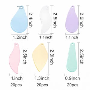 May include: A collection of six cosmetic spatulas in pastel shades: blue, white, lilac, pink, yellow, and mint green. Each spatula is approximately 6.1 to 6.6 cm long and 2.3 to 3.3 cm wide. The set includes various shapes.