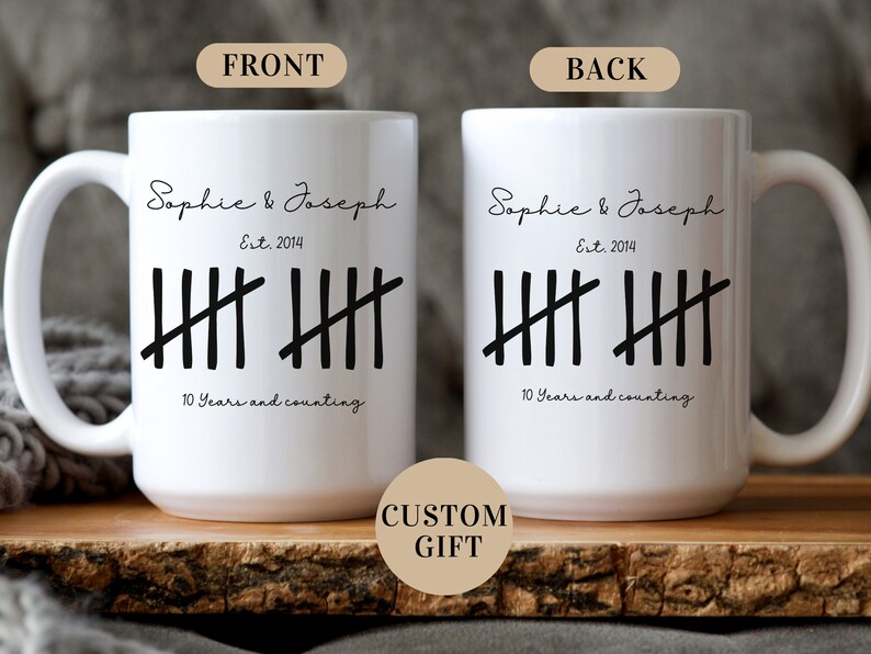 May include: White ceramic mug with black text that reads "Sophie & Joseph Est. 2014" and a tally mark graphic that says "10 Years and counting".