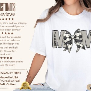May include: White t-shirt with a gray "MOM" design featuring a soccer ball bow and the name "JASON" and the number "21".