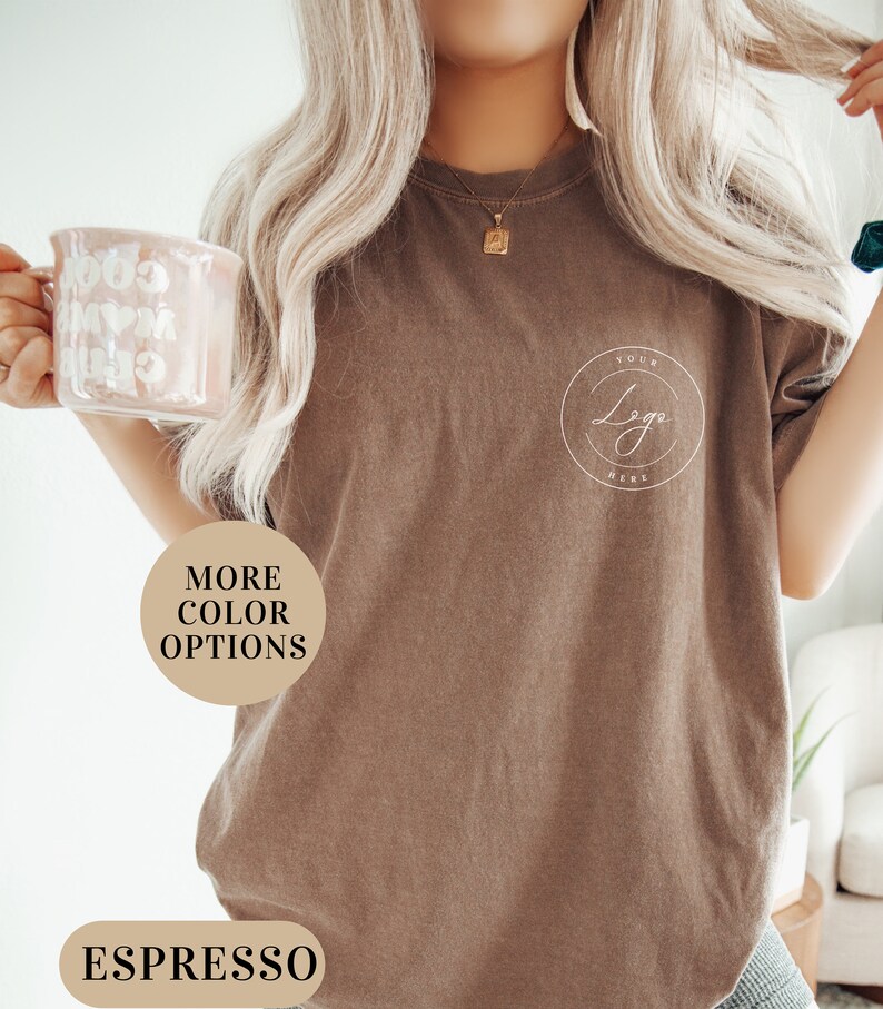 May include: A brown t-shirt with the text "Your Logo Here" in a circle on the front. The shirt is made of a soft, comfortable material and has a relaxed fit. More color options are available.