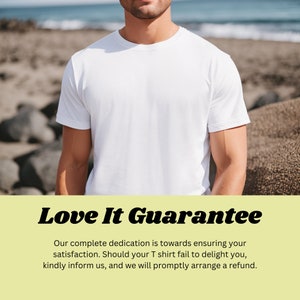 May include: A white t-shirt with the text "Love It Guarantee" in bold black letters. The text below reads "Our complete dedication is towards ensuring your satisfaction. Should your T shirt fail to delight you, kindly inform us, and we will promptly arrange a refund."