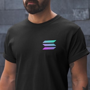 May include: Black t-shirt featuring a gradient logo of three horizontal lines in shades of teal, blue, and purple. The logo is positioned on the left chest area of the shirt. The shirt has short sleeves and a crew neck.