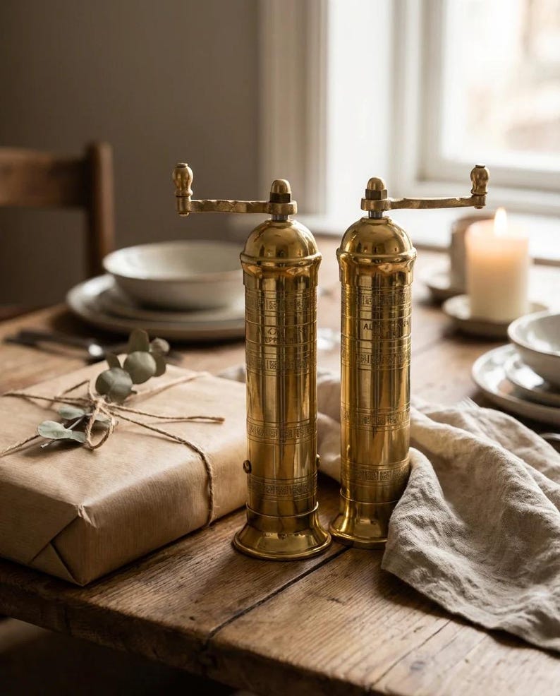 lifestyle shot of brass salt pepper mill set