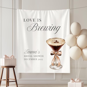 May include: A white striped backdrop with the text "Love is Brewing" and "Emma's Bridal Shower December 2025." A watercolour illustration of a cocktail with coffee beans and a ribbon is displayed. Balloons and gifts are also present.