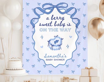 May include: A light blue baby shower banner with the text "a berry sweet baby is ON THE WAY". The banner has a bow and ribbon design, with the name "Samantha's" and "BABY SHOWER" at the bottom. White and gold balloons are in the background.