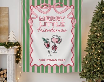 May include: A festive tapestry with a white center featuring the text "MERRY LITTLE Friendsmas" and "CHRISTMAS 2025" in red script. The design includes two illustrated cocktail glasses and is framed by a pink ribbon and a scalloped border. The background has green and pink vertical stripes.