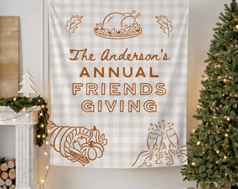 May include: Thanksgiving-themed tapestry with a tan and white checkered pattern. The tapestry features brown illustrations of a roasted turkey, cornucopia, and champagne flutes. Text reads "The Anderson's ANNUAL FRIENDS GIVING."