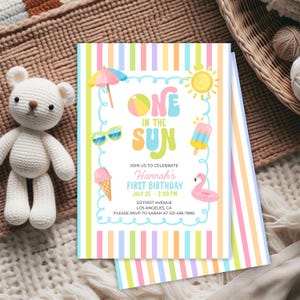 May include: A colorful invitation for a first birthday party with a beach theme. The invitation features the text "One in the Sun" with illustrations of a sun, sunglasses, ice cream, and a flamingo. The invitation includes the party details.