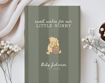 Puede incluir: Un diario de bebé personalizado con una cubierta a rayas verdes. La cubierta presenta el texto "sweet wishes for our LITTLE HUNNY" y una ilustración de Winnie the Pooh. Debajo de la ilustración está el nombre del bebé y el año 2025.