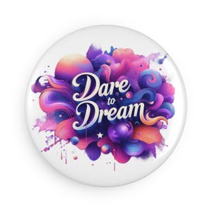 May include: A white button with a colourful abstract design featuring swirls of pink, purple, and blue. The text "Dare to Dream" is written in a white, stylised font.