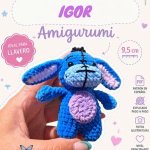 May include: A blue and light purple crochet amigurumi donkey toy with black stitched details. The text on the image includes PATRON, IGOR, Amigurumi, IDEAL PARA LLAVERO, 9.5 cm, PDF, PATRON EN ESPAÑOL, EXPLICADO PASO A PASO, FOTOS ILUSTRATIVAS, NIVEL PRINCIPIANTE, NINA MERAKI, and NINAMERAKI11.