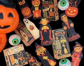 May include: A collection of vintage-style Halloween blow mold lights and their original boxes, featuring figures of a pumpkin, owl, ghost, vampire, witch, black cat, and scarecrow, alongside several round, white, and green eyeball decorations.