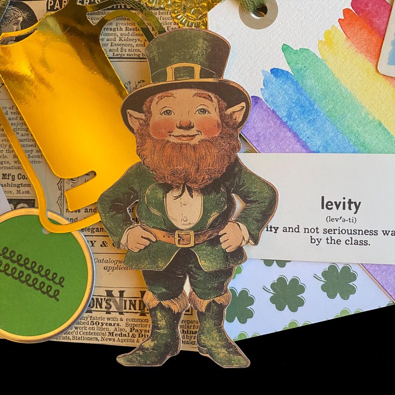 May include: A vintage illustration of a leprechaun wearing a green suit and a hat with a gold buckle. The illustration is surrounded by green shamrocks and a definition of the word "levity" on a white background.