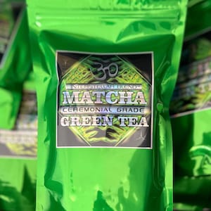 May include: A green resealable pouch with a label that reads "Interstellar Blend Matcha Ceremonial Grade Green Tea".