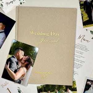 The Wedding Day journal surrounded by wedding pictures and other wedding paper memorabilia.